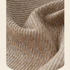 Close-up of a beige chenille sofa protector cover showing the textured weave and folds.
