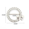 A circular metal ring clip decorated with clear stones and featuring a bow detail.