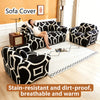 Black and white patterned sofa cover displayed on a living room floor with natural light.