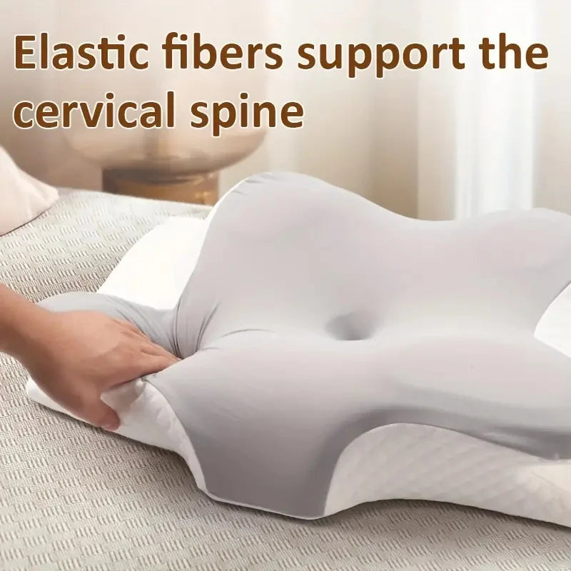 A hand is adjusting a white memory foam contour neck pillow on a light-colored surface.