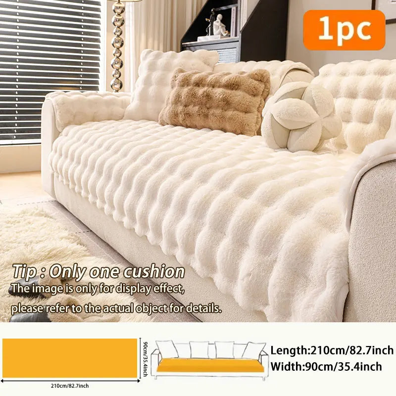 A beige plush anti-slip sofa cushion with decorative fluff and a yellow accent on a light-colored sofa.
