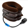 A stack of dark brown inflatable cervical traction neck stretchers or pillows with a black hose attached.