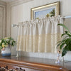 A cream colored rustic crochet half curtain with a linen weave hanging over a window.