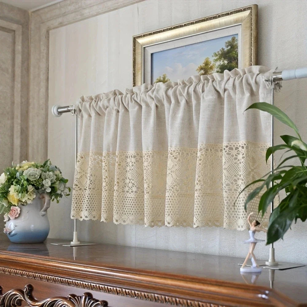 A cream colored rustic crochet half curtain with a linen weave hanging over a window.