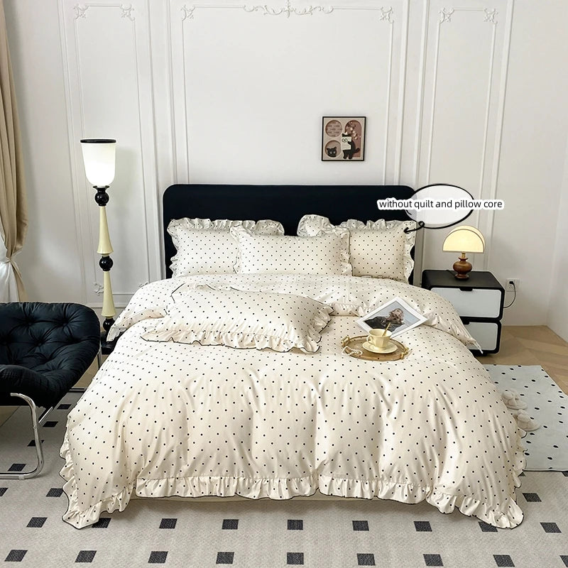 A white Korean lace duvet cover set displayed on a bed with black bedding and light gray flooring.