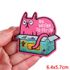 Pink cartoon cat embroidered iron-on patch featuring a distressed look and an open box design