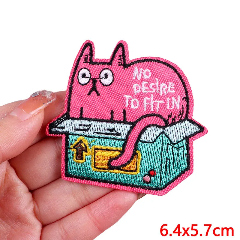 Pink cartoon cat embroidered iron-on patch featuring a distressed look and an open box design