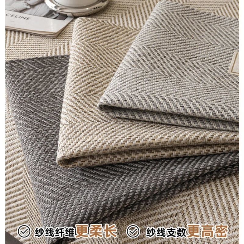 Stack of beige and gray linen sofa cover cushions showing texture and weave