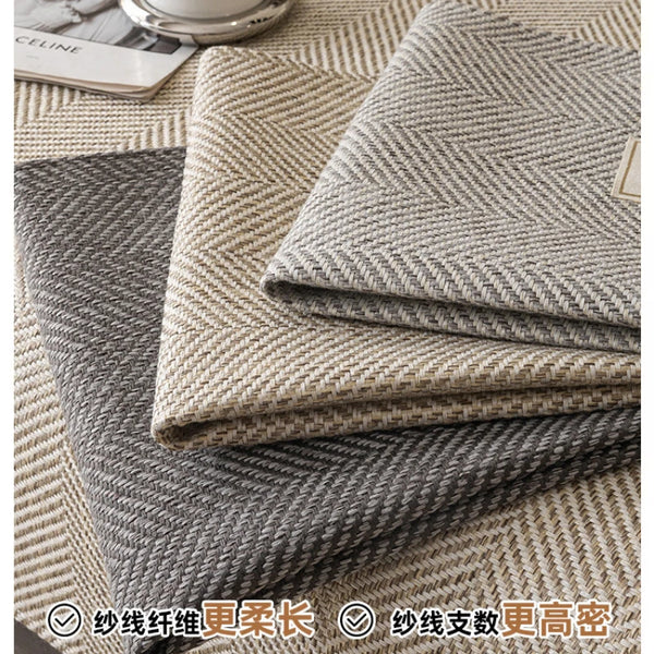 Stack of beige and gray linen sofa cover cushions showing texture and weave