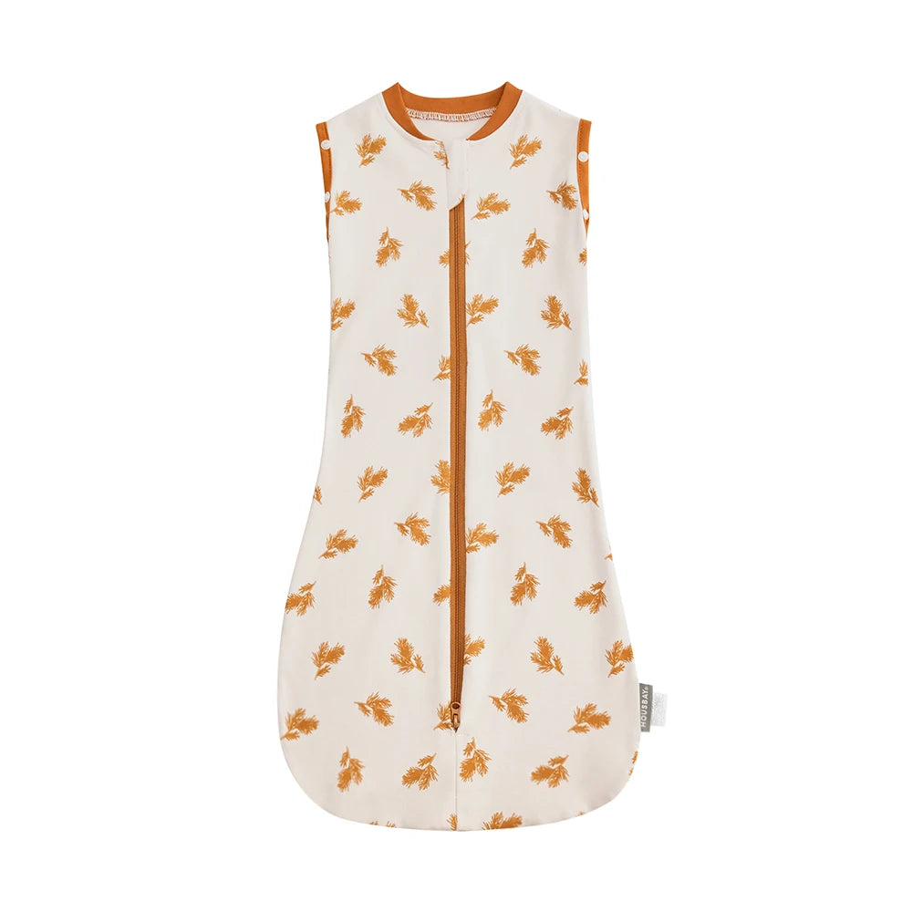 A cream-colored soft cotton baby sleeping bag or swaddle with small orange floral embroidery.