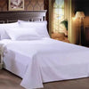White premium flat bed sheet spread on a wooden bed frame with a decorative headboard and natural light.