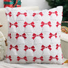 White knitted cushion cover with red bow pattern for a Christmas decoration