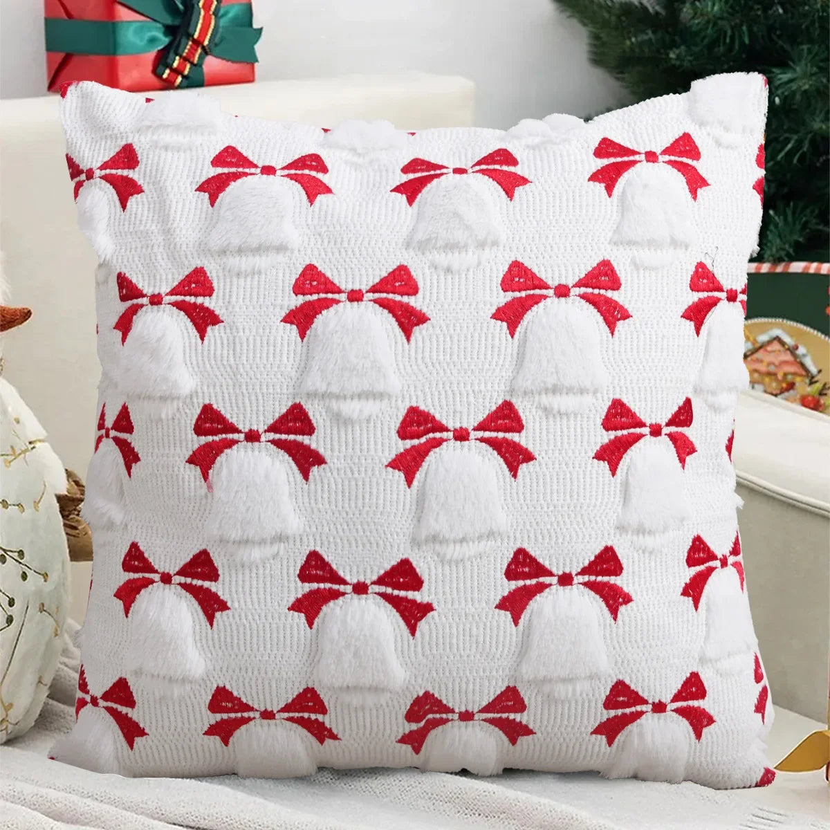 White knitted cushion cover with red bow pattern for a Christmas decoration