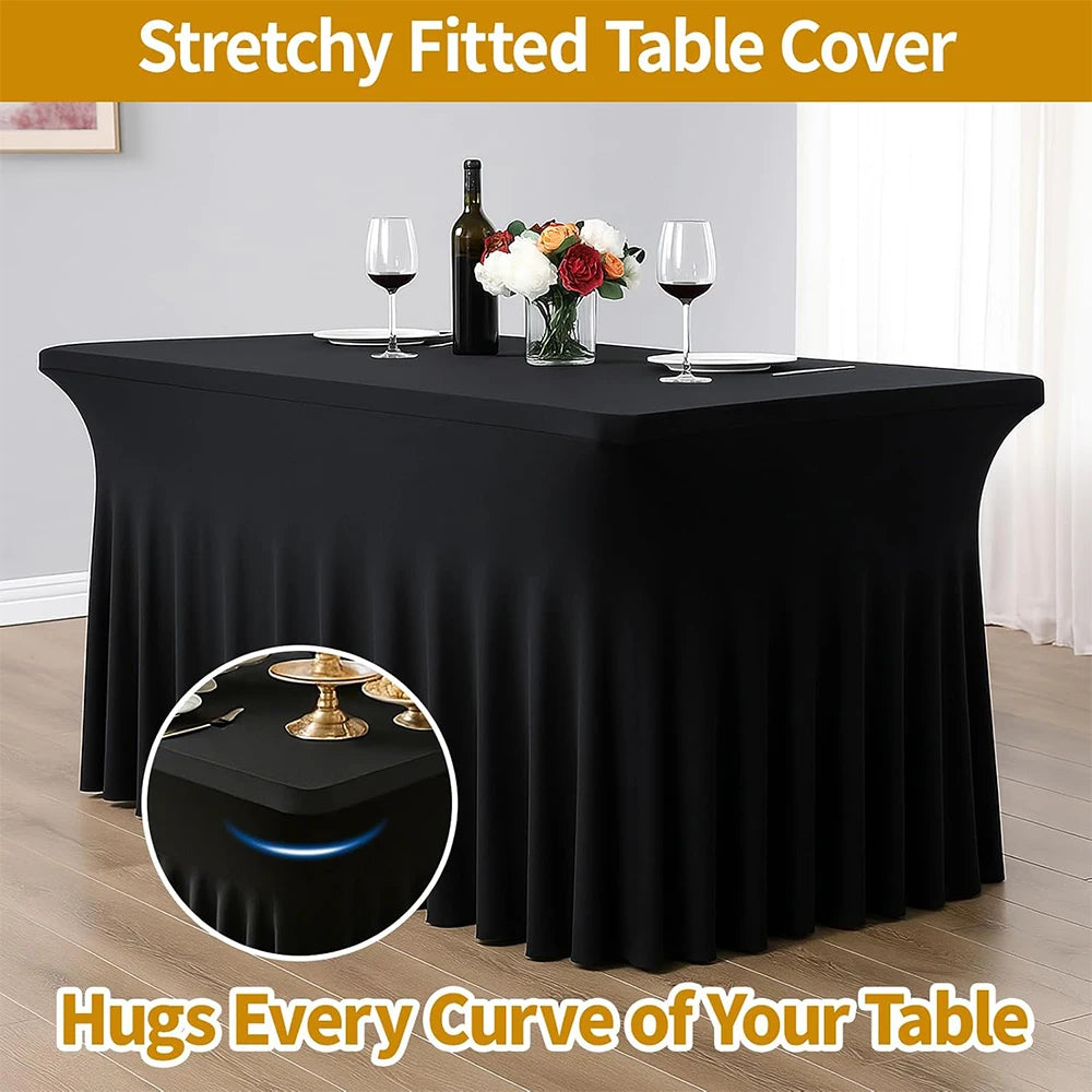 Black stretchy fitted table cover draped on a table with wine glasses and flowers.