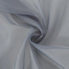 A soft gray sheer voile curtain panel draped in a flowing, gathered fabric.