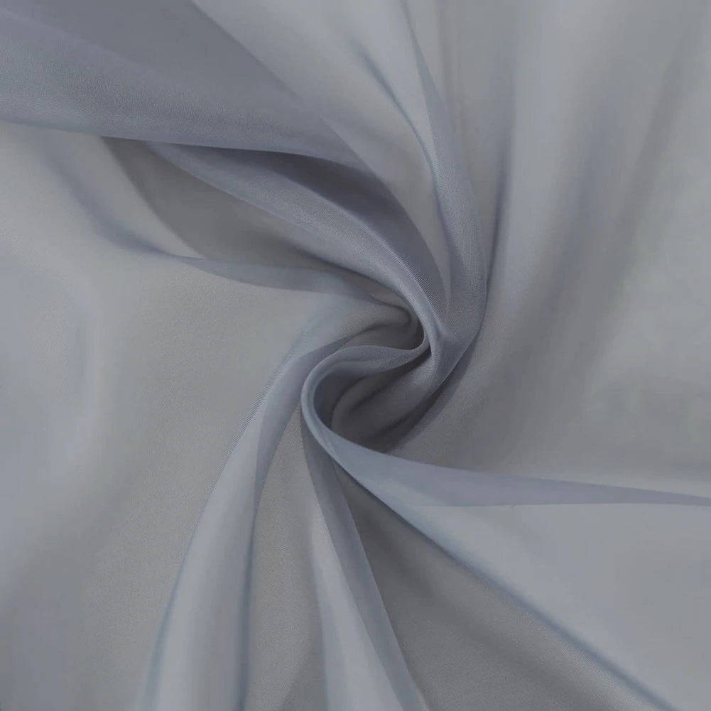 A soft gray sheer voile curtain panel draped in a flowing, gathered fabric.
