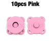A pair of pink metal magnetic snap buttons for sewing.