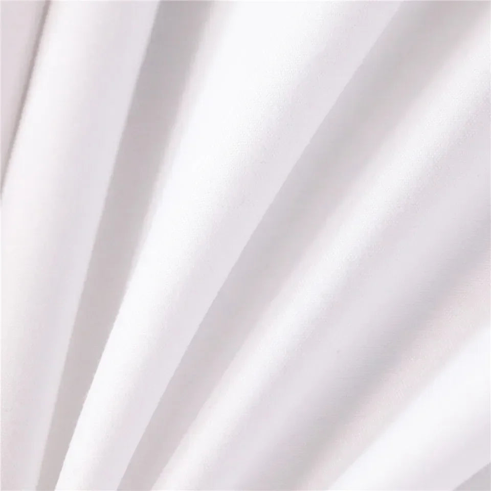 White fabric draped in soft folds, showing texture and light shadows.