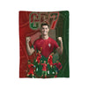 A football player wearing a red jersey celebrates with his fist raised against a background featuring the text CR7.