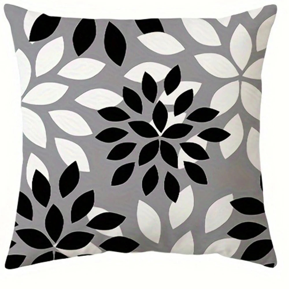 A square pillowcase cover featuring a modern geometric print pattern in black, white, and gray leaves.