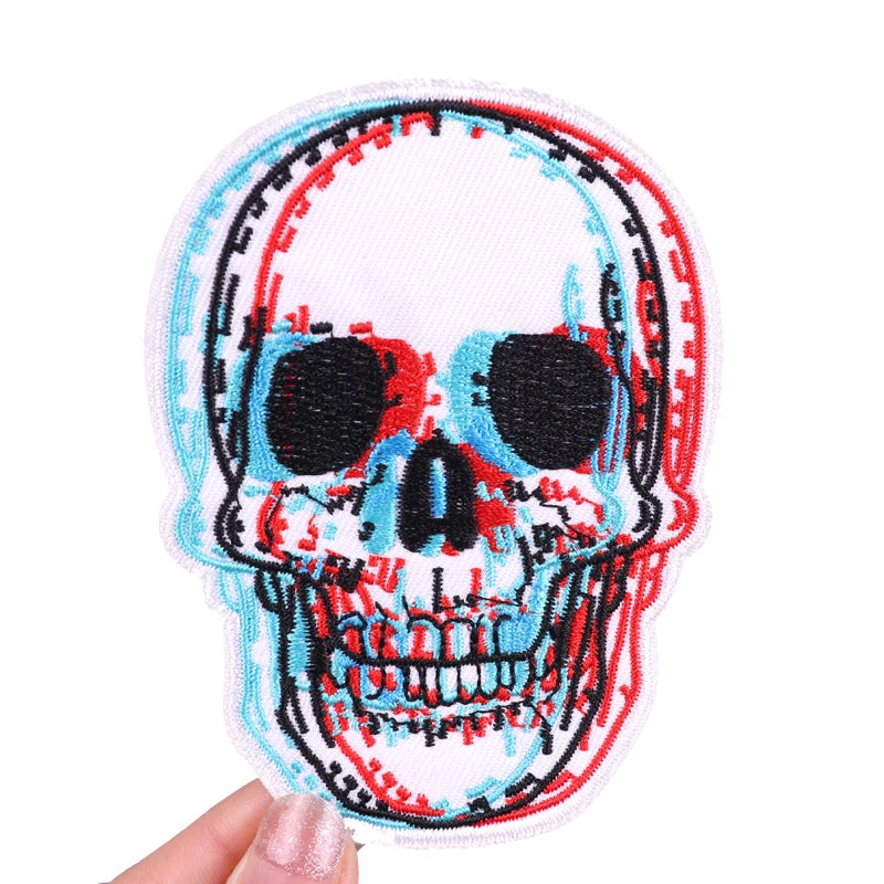Embroidered skull iron-on patch featuring red and blue stitching on a white background