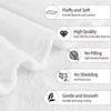 A close-up of a white flannel blanket showing features like fluffiness, high quality stitching, and durability.
