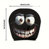 A black decorative smiley face design featuring large eyes and a wide, toothy grin on a fabric item.
