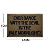 A rectangular brown embroidered patch with black text that reads Ever Dance With The Devil In The Pale Moonlight