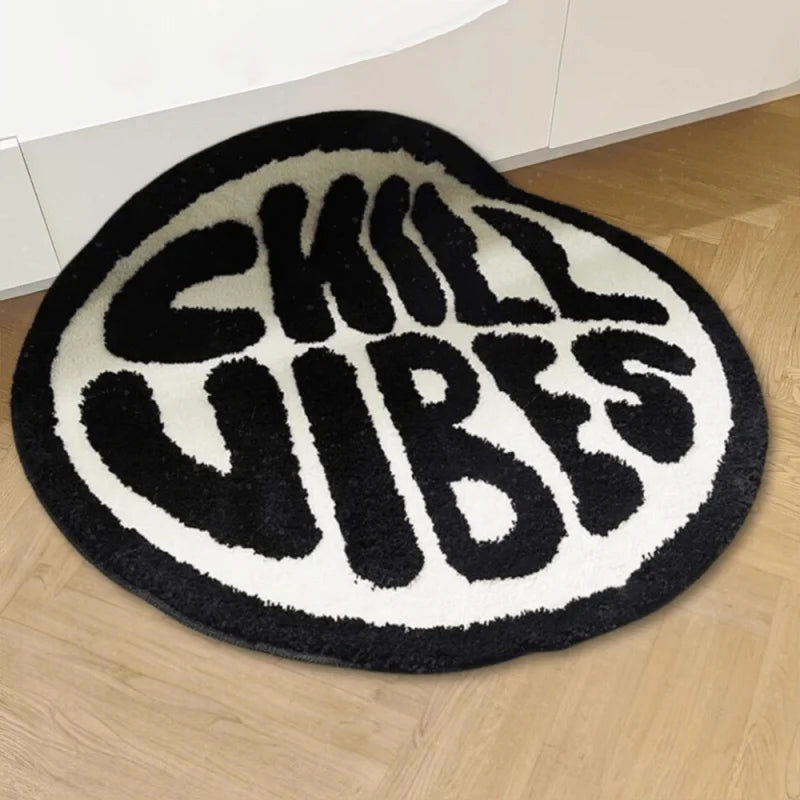 Black and white fuzzy round rug with the text SKILL VIBES in a bold font