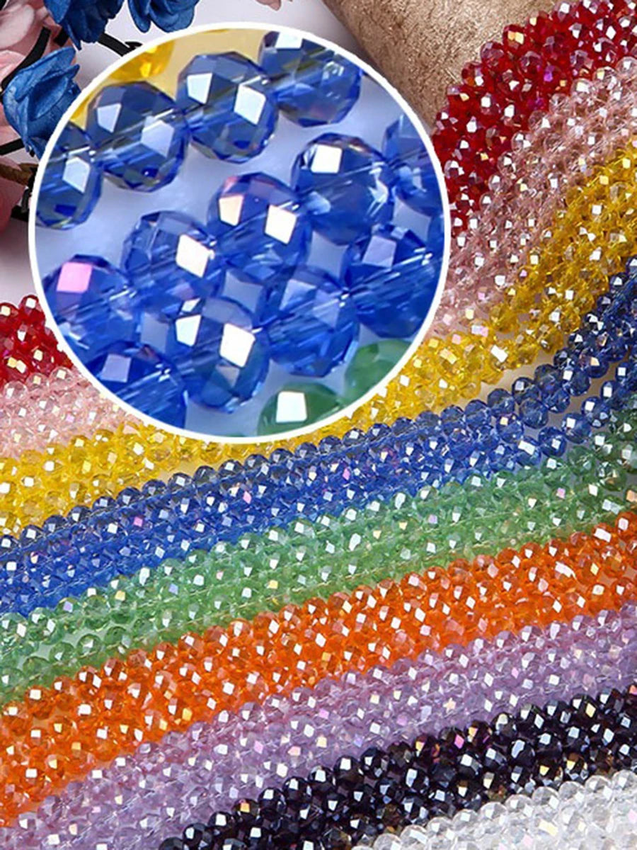 A colorful display of faceted rondelle glass beads in various shades including blue, green, orange, and purple.
