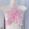 Pink floral lace applique fabric patches with sparkling sequins displayed on a white mannequin.
