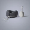 A gray U-shaped memory foam travel neck pillow with a white strap and a separate cooling cover.
