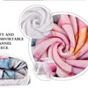 A close-up of a soft and comfortable flannel fleece throw blanket in shades of pink and purple, rolled into a swirl.