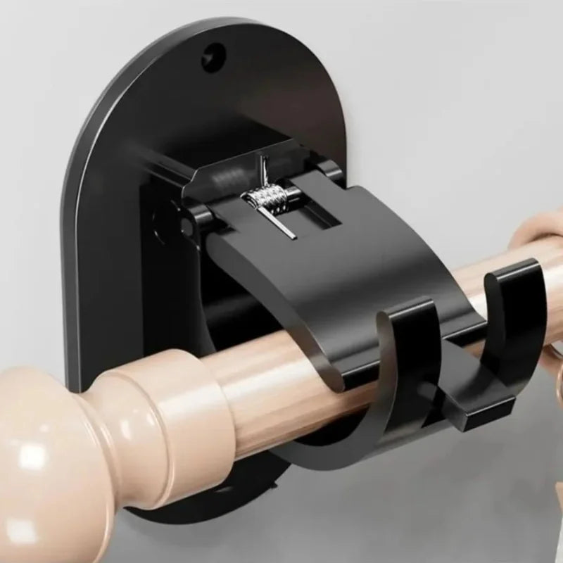 A close-up of a black curtain rod holder clamp being attached to a wooden curtain rod.