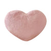 A soft, pink heart-shaped throw pillow.