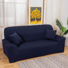 A navy blue elegant faux silk sofa cover displayed in a living room setting with a window and artwork.
