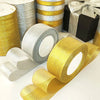 Rolls of glitter organza ribbon in gold and silver colors for gift wrapping and crafts