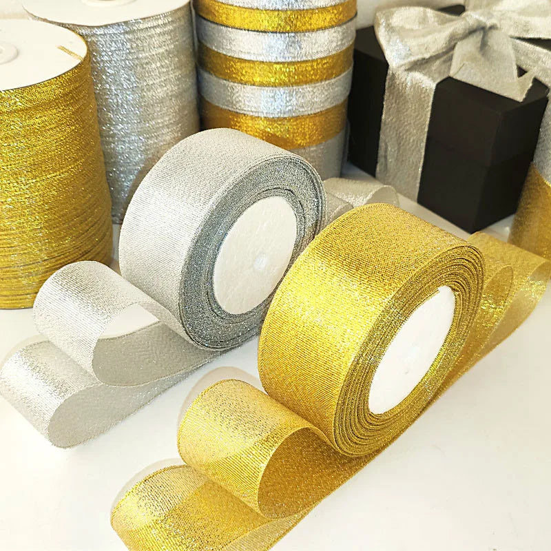 Rolls of glitter organza ribbon in gold and silver colors for gift wrapping and crafts