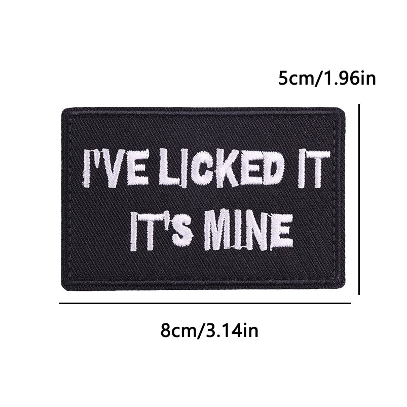 Black iron-on embroidery patch with white text that reads I'VE LICKED IT IT'S MINE