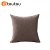 A square, textured brown linen cushion cover with a button closure.