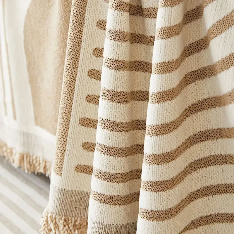 Close-up of a beige and tan striped plush chenille sofa cover fabric.