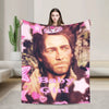 A pink and purple patterned flannel throw blanket featuring a portrait of a man labeled Baby Girl