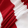 A close-up of a red and white fabric drape, likely a duvet cover set.