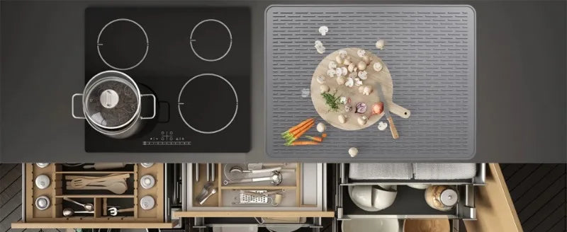 A heat-resistant silicone stove top cover mat is shown with various cooking tools and ingredients on a dark stovetop.