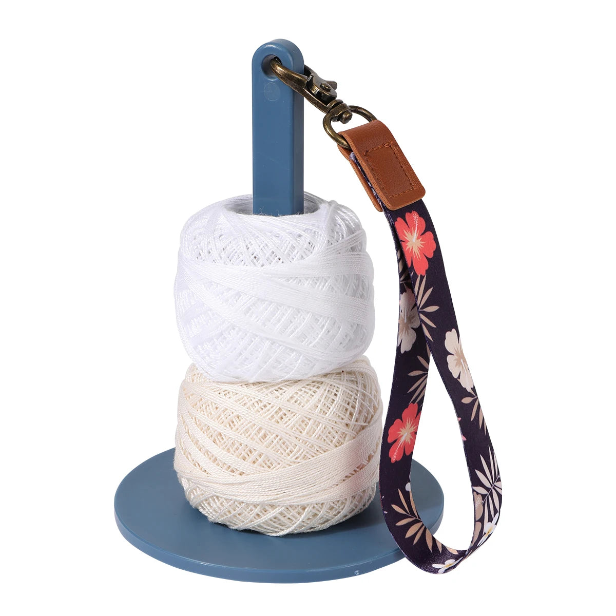 A white yarn holder with a blue rod and a brown leather strap featuring a floral pattern.