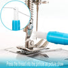 A close-up of a 2-in-1 automatic needle threader tool with a blue component pressing a thread into a pinhole.