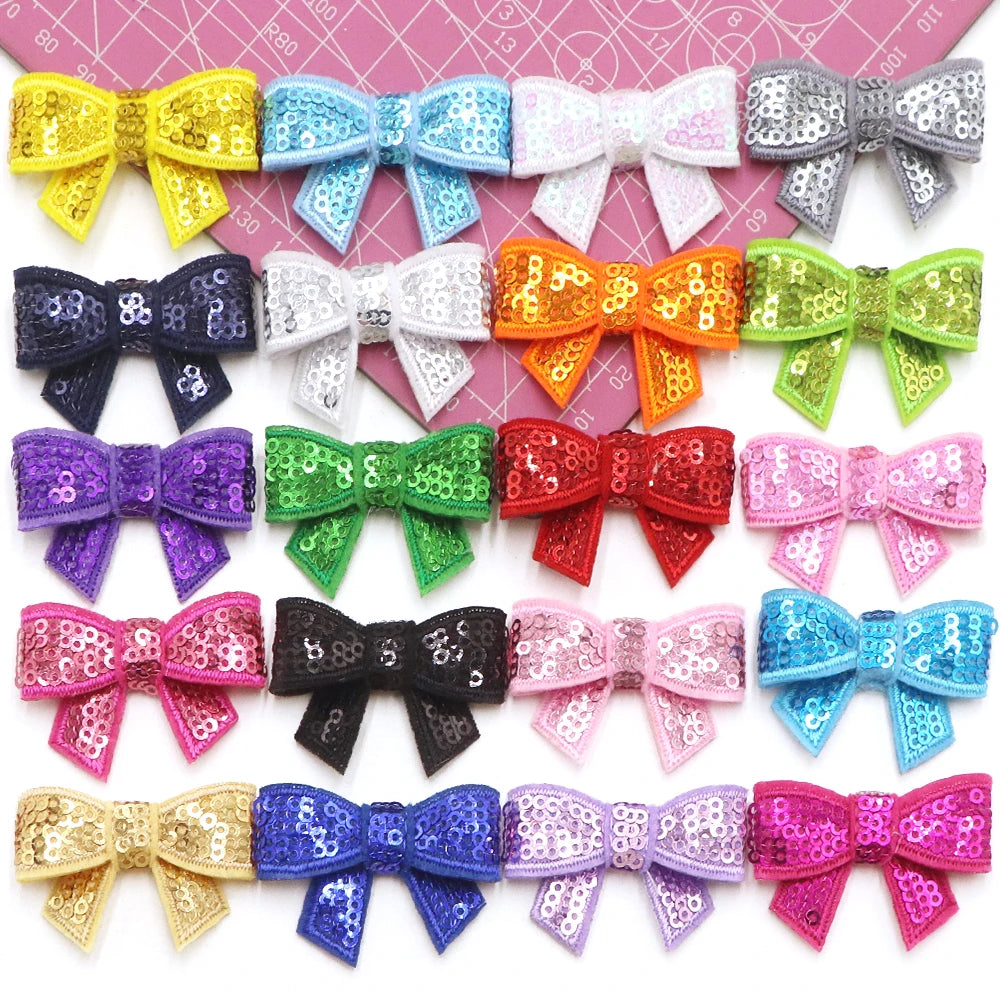 Assortment of sparkly and glittery bow patches in various colors for DIY decoration