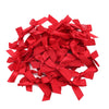A pile of bright red satin ribbon bows for craft and decoration.