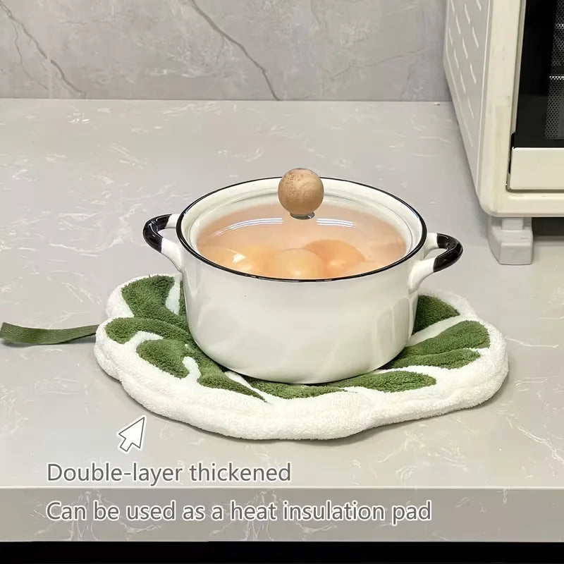 A white double-layer thickened pot is shown on a light surface with a green towel underneath.