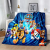 A blue and yellow Paw Patrol themed flannel throw blanket featuring cartoon dogs in action poses.